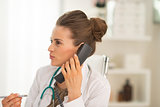 Portrait of medical doctor woman talking phone