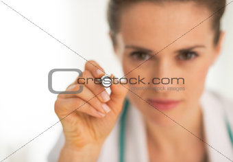 Closeup on medical doctor woman examining using flashlight