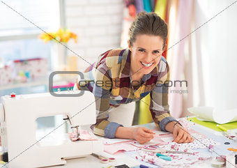 Happy seamstress working in studio