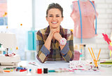 Portrait of smiling seamstress in studio