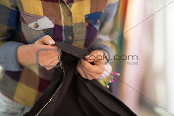 Closeup on seamstress working with fabric