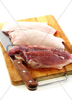 Duck breast on a cutting board.