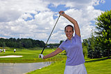 Female golfer stretching with a golf club