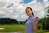 Woman golfer stretching with a golf club