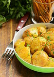 tasty baked potatoes with herbs in the pan
