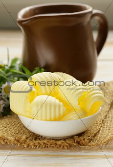 fresh yellow dairy butter in a white bowl