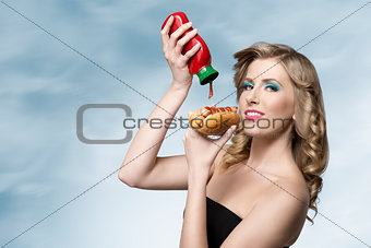 woman with ketchup and hot-dog 