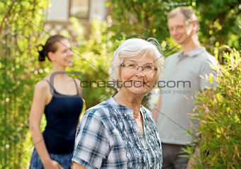 Senior woman in front of  a young couple 