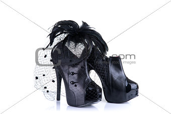 Black high heel female shoes and feather hair fascinator  