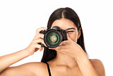 Closeup portrait of a young woman holding a camera over white