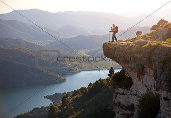 Hiker with baby relaxing on cliff and enjoying valley view. Siurana, Spain