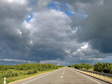 Most asphalt road,  against the background of clouds