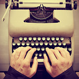 man typing on an old typewriter, with a retro effect