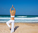 Healthy yoga exercise on the beach