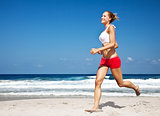 Healthy woman running on the beach