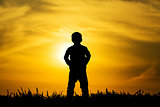 Silhouette boy on sunset