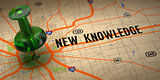 New Knowledge  - Green Pushpin on a Map Background.