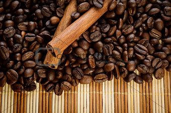 handful aromatic coffee beans with cinnamon 