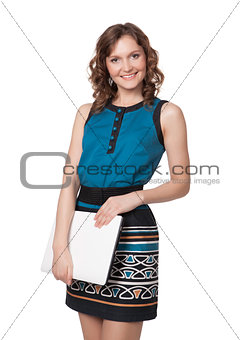 Portrait of a happy young woman posing with a laptop