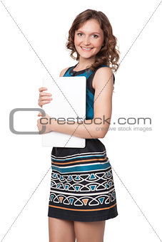 Portrait of a happy young woman posing with a laptop