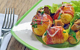 Baked potatoes wrapped in bacon