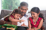 Indian family using tablet computer.