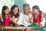Happy Indian family playing carrom game