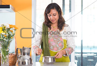 Indian housewife preparing food