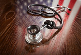 Knotted Stethoscope with American Flag Reflection on Table