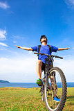 close-up man sitting on a  mountain bike and open arms to relax