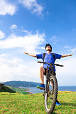 young backpacker sitting on a  mountain bike and relaxing pose