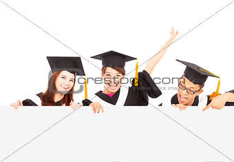 happy young graduate students with blank board