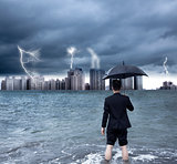 business man holding an umbrella with thundershower background
