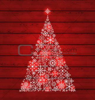 Christmas fir made of snowflakes on wooden background