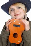Cute blond cowgirl holding small orange guitar