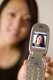 Asian woman sharing camera phone image