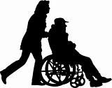 woman pushing man in the wheelchair