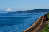 Train on Tracks Going By Pacific Ocean Mount Baker Background