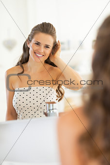 Portrait of happy young woman in bathroom