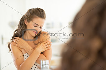 Portrait of relaxed young woman in bathroom