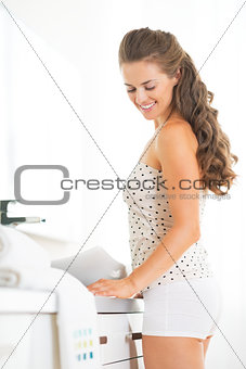 Happy young woman in bathroom