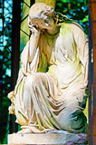 female statue in a dress of white marble