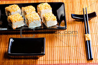 traditional Japanese rolls on a black dish