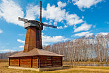Beautiful wooden windmill in a field in spring