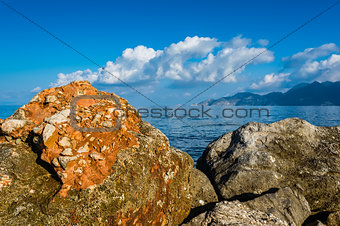 Rocks, sea and blue sky with clouds
