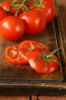 fresh ripe organic sliced tomatoes on a wooden table