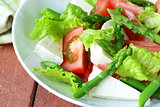 fresh salad with tomatoes, asparagus and cheese