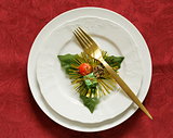 Christmas table setting (white plates on a red background)