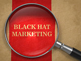 BlackHat Marketing Concept Through Magnifying Glass.