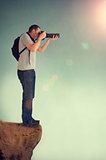 photographer on cliff ledge